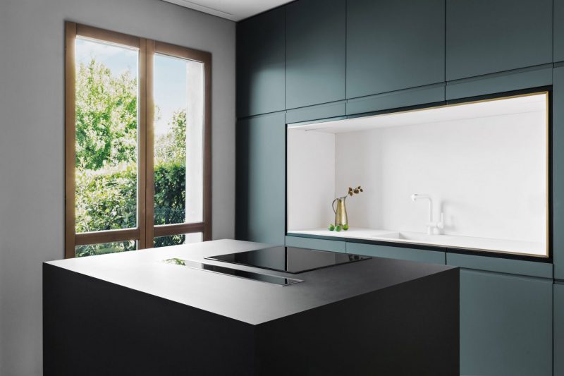 Strakke moderne keuken met blauwe wandkast en zwart kookeiland